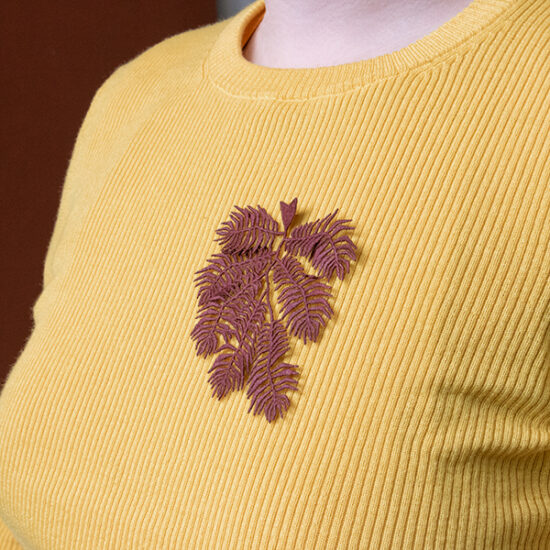 Knight’s plume fern embroidered brooch on shirt