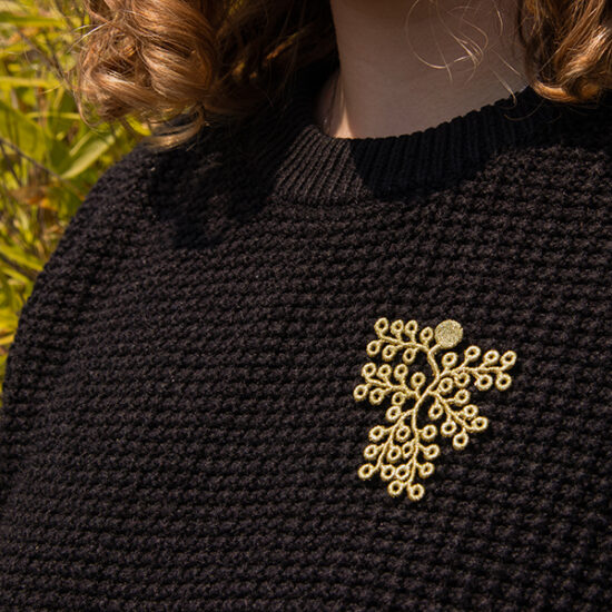Spikemoss embroidered brooches on shirt