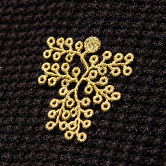 Spikemoss embroidered brooches on shirt close up